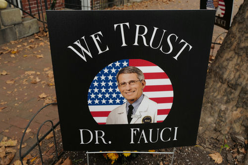 shutterstock1840078672-2jpg Sign reading We Trust Dr. Fauci on display.