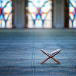 Public Schools Install Islamic Prayer Rooms—Christians FURIOUS Quran on stand inside mosque with stained glass windows.