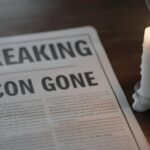 TRAGIC End: Sports Star Dead After TRAIN Accident… A newspaper with the headline 'BREAKING ICON GONE' next to a lit candle