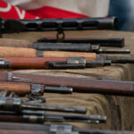 Old rifles displayed on a table