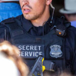 Secret Service officer wearing tactical gear and radio.