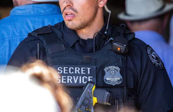 2346861587 Secret Service officer wearing tactical gear and radio.