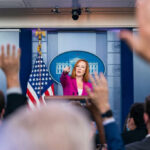 Texas Democrat’s SHOCKING Anti-Zionist Crusade Press secretary at podium, answering reporters questions, raised hands.