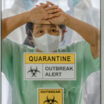 Ebola’s PERFECT STORM: Are We Really Ready? Person wearing mask behind quarantine glass, outbreak alert sign.