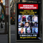 Billboard seeking information about individuals involved in an assault at the U.S. Capitol