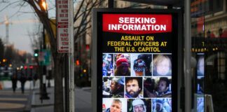 Billboard seeking information about individuals involved in an assault at the U.S. Capitol