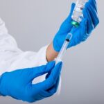 Leaked FDA Memo: Child Deaths Linked to COVID Shots! A healthcare professional preparing a syringe with a vaccine