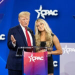 Artists BAIL — Trump Plots Mega Rally Two people speaking at CPAC event stage.