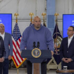 I dont know who these people are. Four men give a presentation.