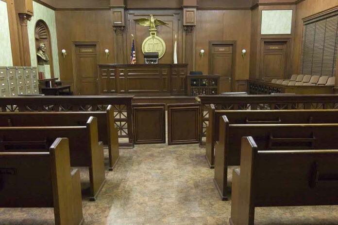 121502665 Empty courtroom with wooden benches and judges bench.