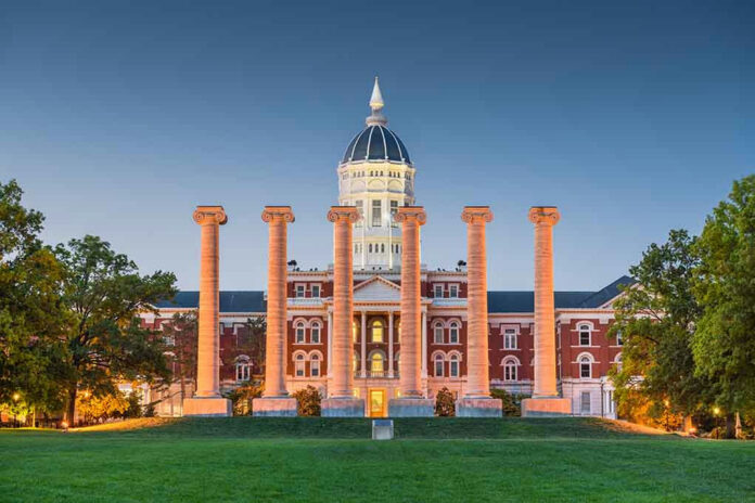 Historic building with columns at sunset, front view.