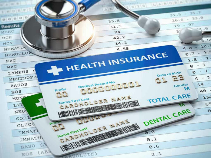 Stethoscope and health insurance cards on medical chart.