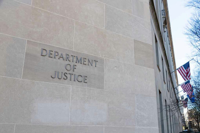1605140956 Department of Justice building with American flags outside.