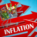 Shopping cart filled with groceries atop Inflation arrow.