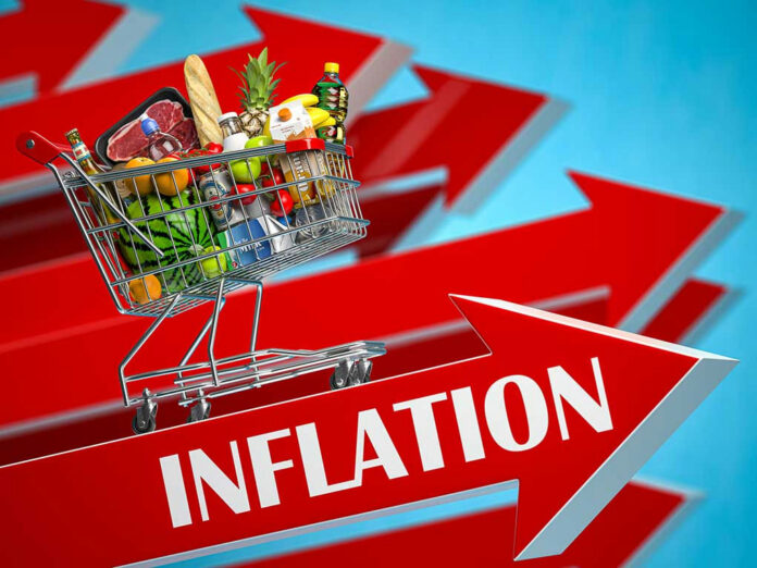 Shopping cart filled with groceries atop Inflation arrow.