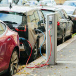 Electric cars charging at street charging stations.