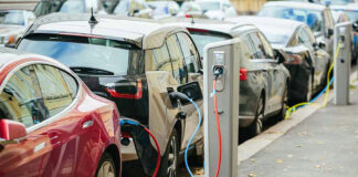 Electric cars charging at street charging stations.