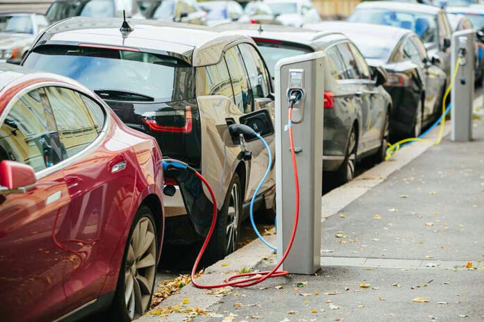 Electric cars charging at street charging stations.