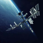 Space Station Scare—Dragon Becomes Lifeboat Space station orbiting Earth surrounded by dark sky.