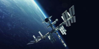Space station orbiting Earth surrounded by dark sky.