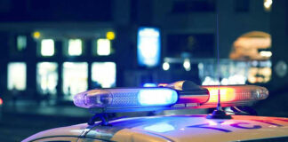 Police car with flashing lights at night.