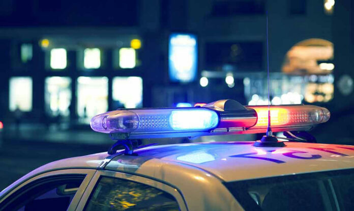 Police car with flashing lights at night.