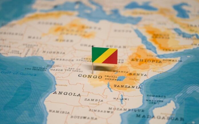 The,Map,And,Flag,Of,Congo. Small Republic of the Congo flag pinned on a map of Africa