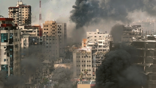 Rimal,Neighborhood,Destroyed,In,The,War,gaza,,Aerial,View,,Drone,View A cityscape showing damaged buildings and thick smoke rising from the ground