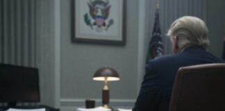 A stack of documents labeled 'Articles of Impeachment' on a desk in a government office