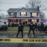 Domestic Dispute Spirals—Seven Dead, Answers Missing FBI agents at a crime scene outside a house with police vehicles and caution tape