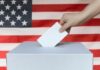 Weeks Before Voting, Trump Nukes Watchdog Hand casting ballot into box before U.S. flag