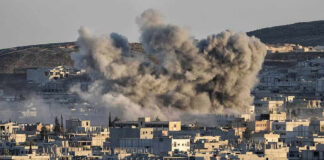 Smoke rising from buildings in a city.