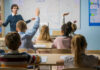 Dozens of Students Rescued After 56 Days in Captivity Students raising hands in a classroom as a teacher leads a lesson