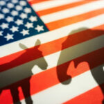 Shadows of a donkey and elephant on an American flag