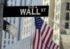 Tax-The-Rich Backfires—Billions Bolt Wall Street sign with American flag in background