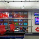 CNN World Headquarters studio with empty red chairs.