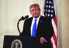 Iran Kill List Claim Stuns NATO A man in a suit standing at a podium with the presidential seal, in front of an American flag