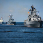 Trump Eyes Hormuz TOLL — Pay Up Several naval warships sailing in the ocean.