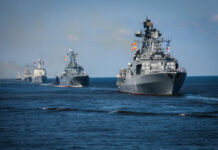 Trump Eyes Hormuz TOLL — Pay Up Several naval warships sailing in the ocean.