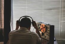 FBI Mole Inside Newsom’s Inner Circle Person wearing headphones listening to a reel-to-reel tape recorder