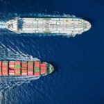 Two cargo ships navigating through the ocean