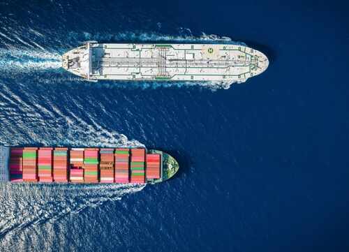 Aerial,Overhead,View,Of,A,Cargo,Container,Ship,And,A Two cargo ships navigating through the ocean