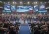 Hypocrisy Alert: Newsom’s Tax Two-Step A political convention with speakers on stage and a cheering crowd holding signs and flags