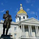 Bronze statue before a domed capitol building