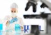 Abortion Pill Traces In Tap Water? Scientist in lab coat handling blue liquid