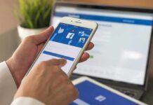 hands using a smartphone with a social media login screen