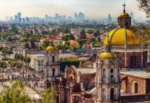 Cartel-Tied Governor Walks Free—Back To Work Basilica domes overlooking a sprawling cityscape with distant skyscrapers