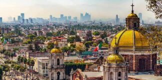 Basilica domes overlooking a sprawling cityscape with distant skyscrapers