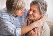 Rushed End-Of-Life Push? Not So Fast Two older women embracing and smiling on a couch