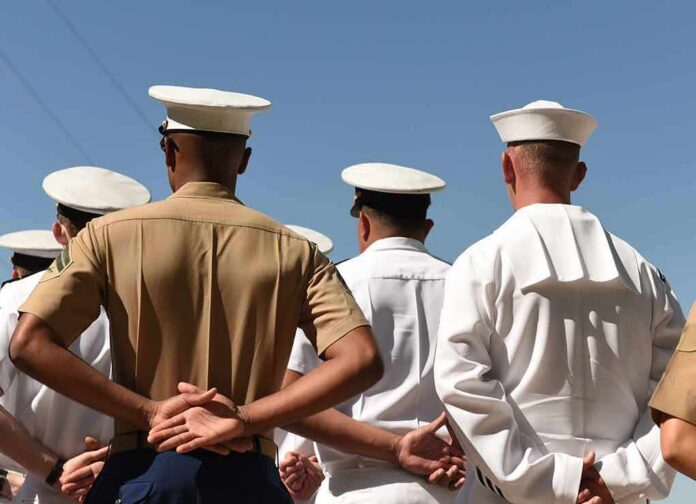 sailors and marines standing in formation with hands behind backs